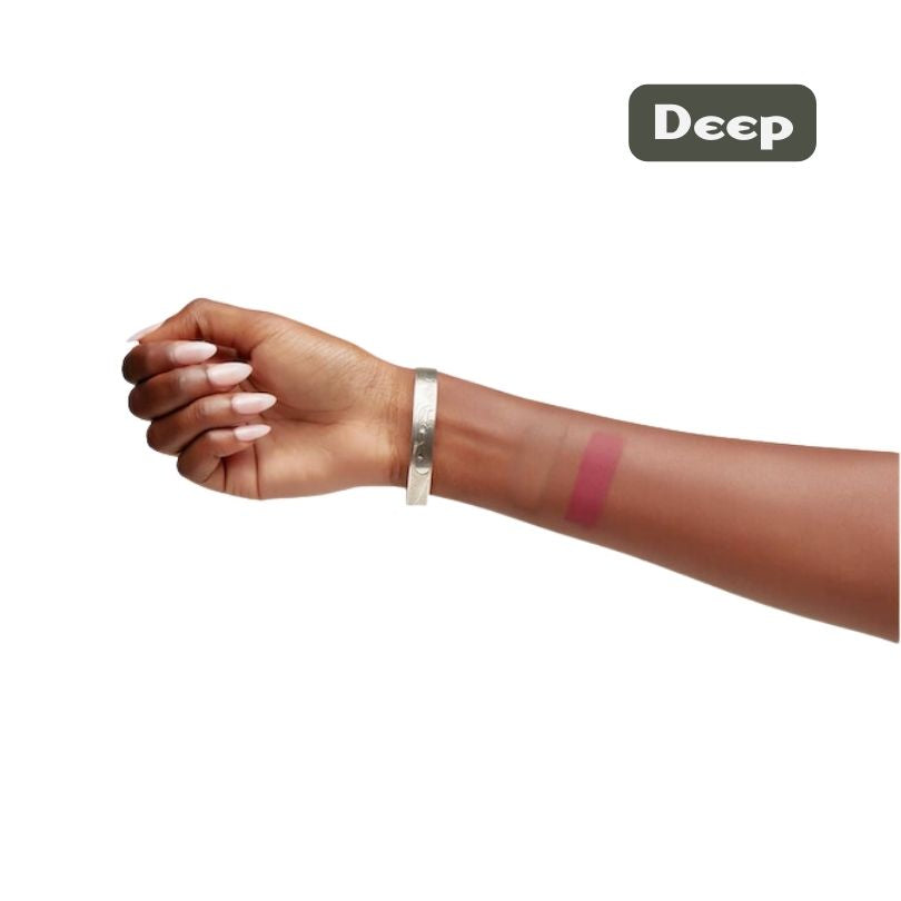 A deep-skinned arm with a silver bracelet shows a pink swatch of Cheekbone Beauty’s Blush & Bronzer Duo (talc-free, vegan) on the inner forearm. “Deep” appears in a box at the top right corner.
