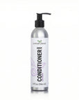A 9 fl oz silver pump bottle of Deep Conditioner by a simple planet, featuring a white label with black and purple text, on a white background.