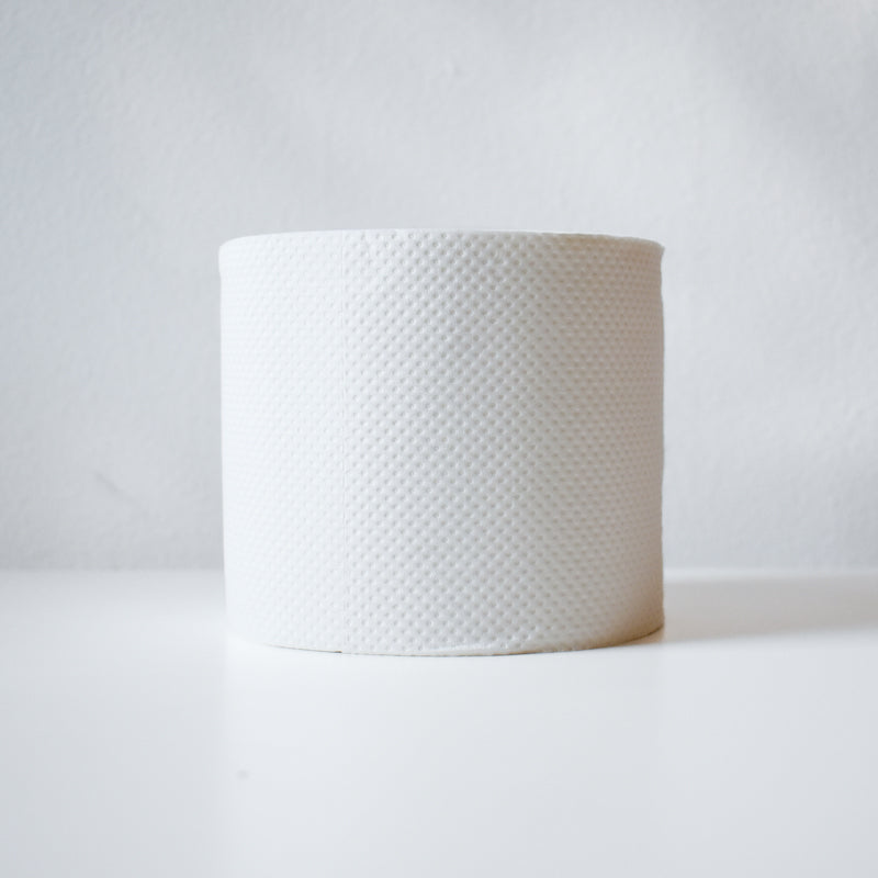 A single roll of Betterway Bamboo Toilet Paper stands upright on a white surface against a plain light background.