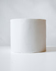 A single roll of Betterway Bamboo Toilet Paper stands upright on a white surface against a plain light background.