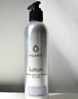 metal lotion bottle on white backdrop