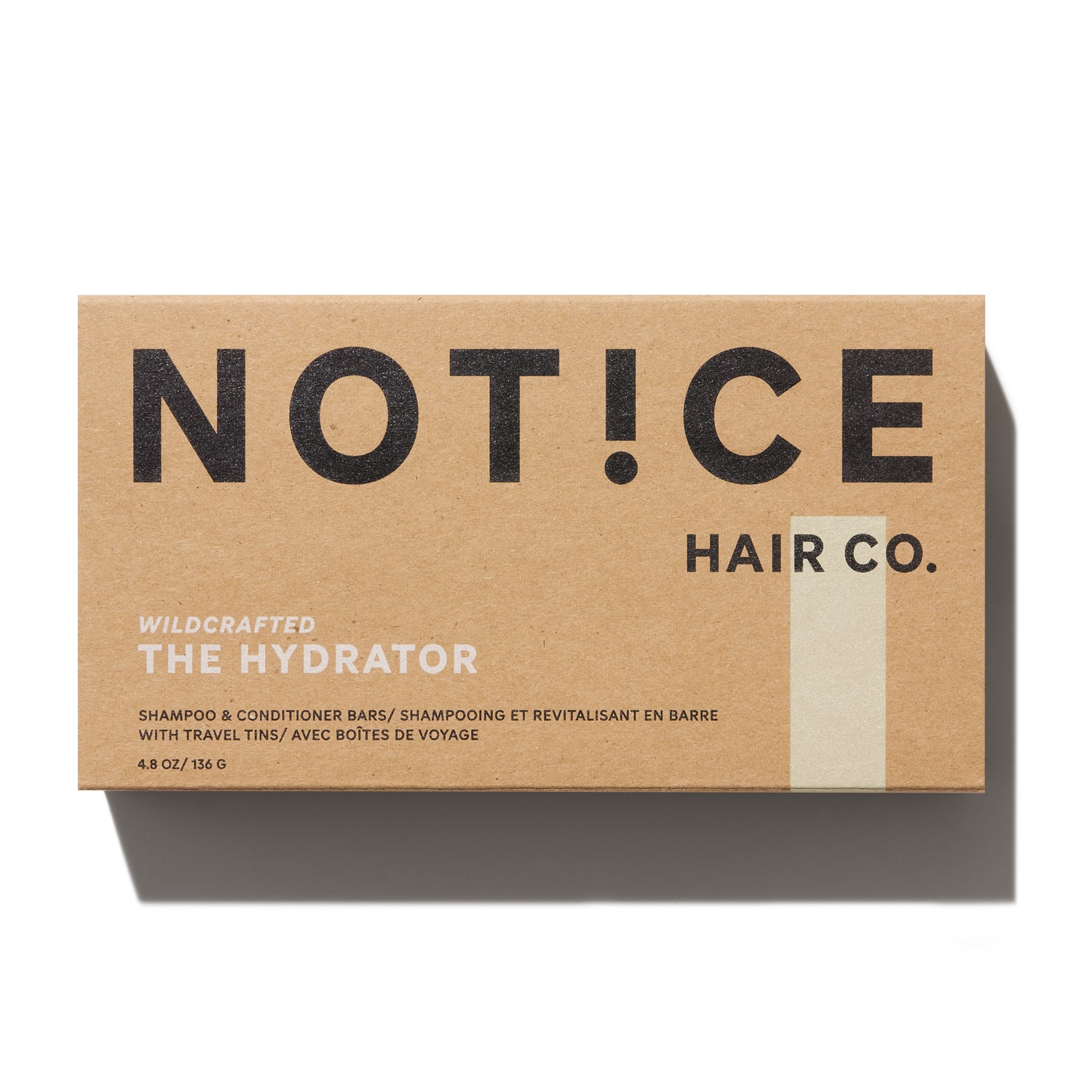 A rectangular brown box labeled Notice Hair Co. showcases minimalist packaging with black and white text, featuring Notice Shampoo & Conditioner Bars in travel tins—perfect for color-treated hair.
