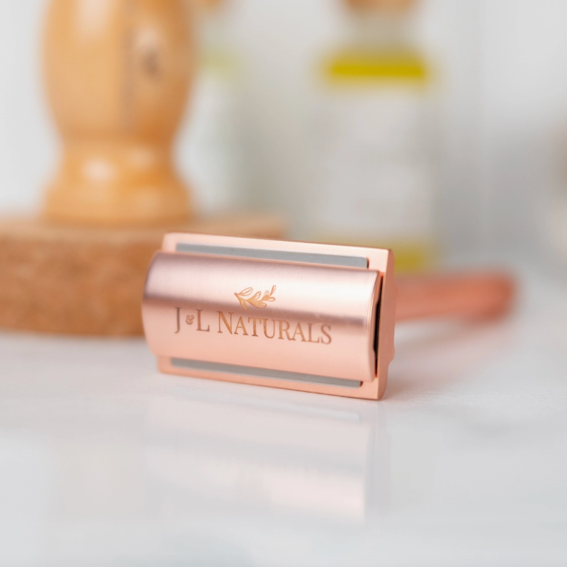 Rose gold razor with 'J&L Naturals' branding on a light background