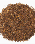 A close up of loose rooibos tea on a white background.