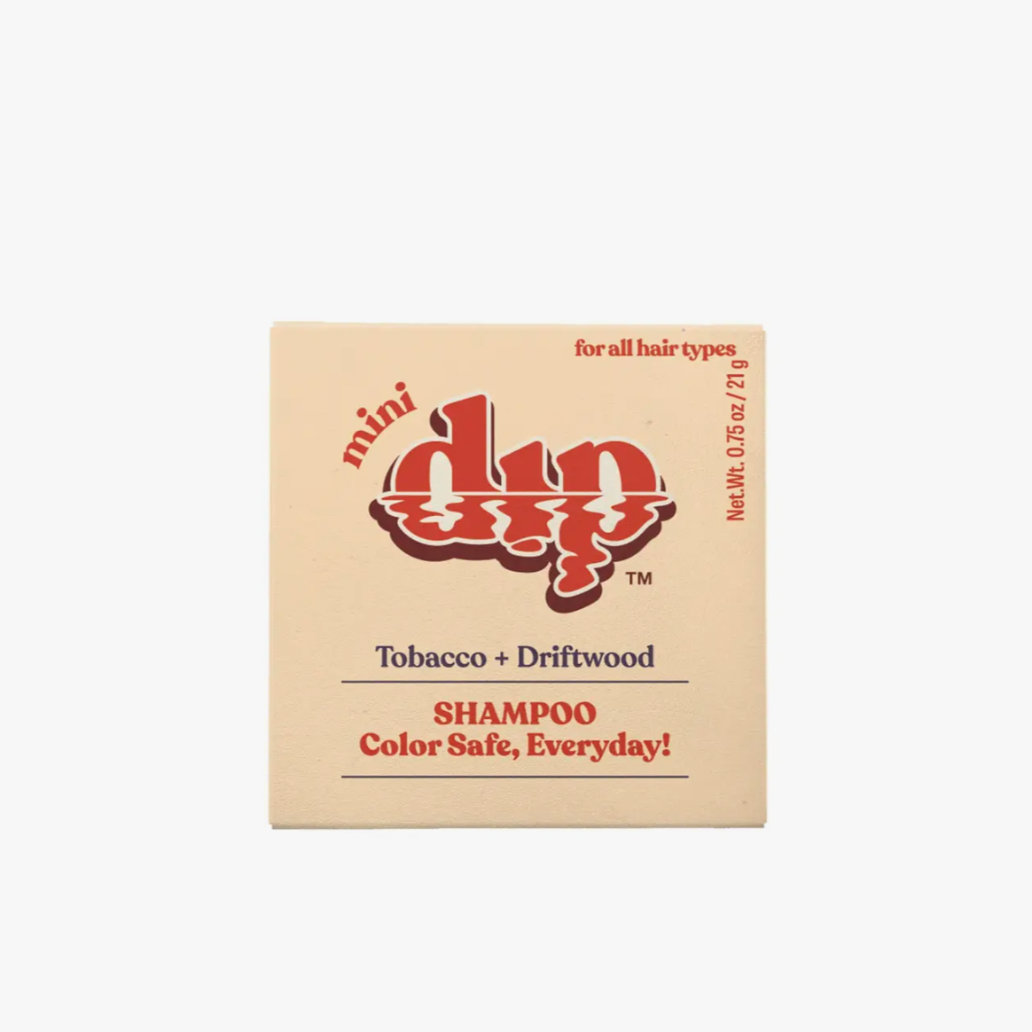A small square box of the Dip Shampoo Bar Mini by Dip, labeled Tobacco + Driftwood and suitable for all hair types and color-treated hair—travel friendly, color safe, and perfect for daily use—displayed on a plain white background.