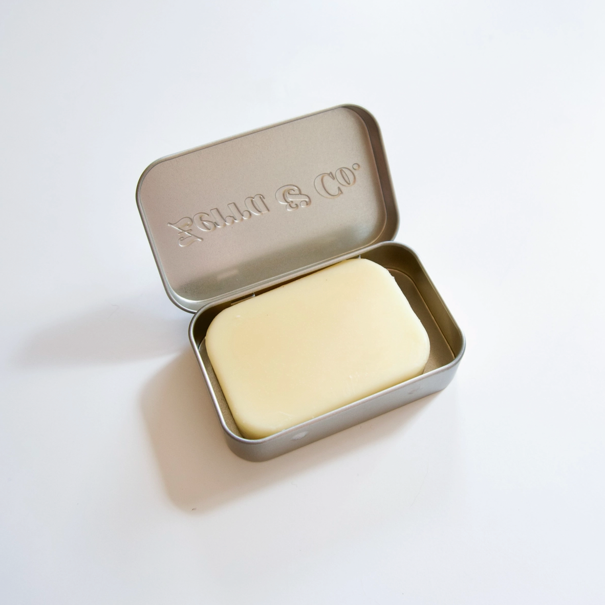 lotion bar in tin on white background