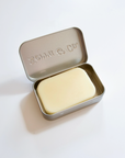 lotion bar in tin on white background