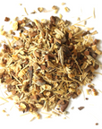 A blend of brown and tan dried herbs and roots from Mountain Rose Herbs Winter Spice Herbal Tea, scattered on a white background.