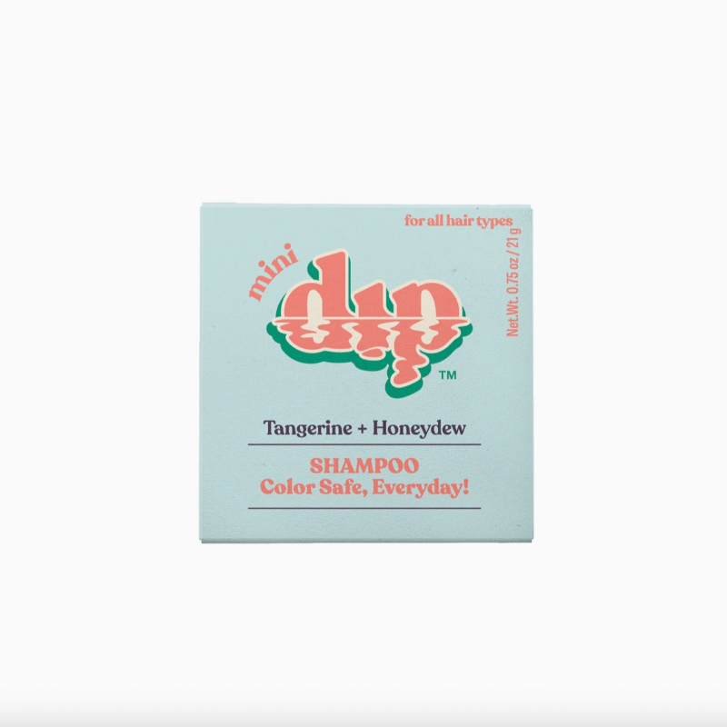 The Dip Shampoo Bar Mini by Dip is a light blue, travel-friendly 0.75 oz bar for all hair types with a tangerine and honeydew scent. Color Safe, Everyday! is written in red at the bottom. Perfect for color-treated hair.