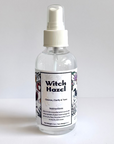 Clear spray bottle labeled 'Witch Hazel' on a white background