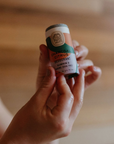 hands holding tube of deodorant 