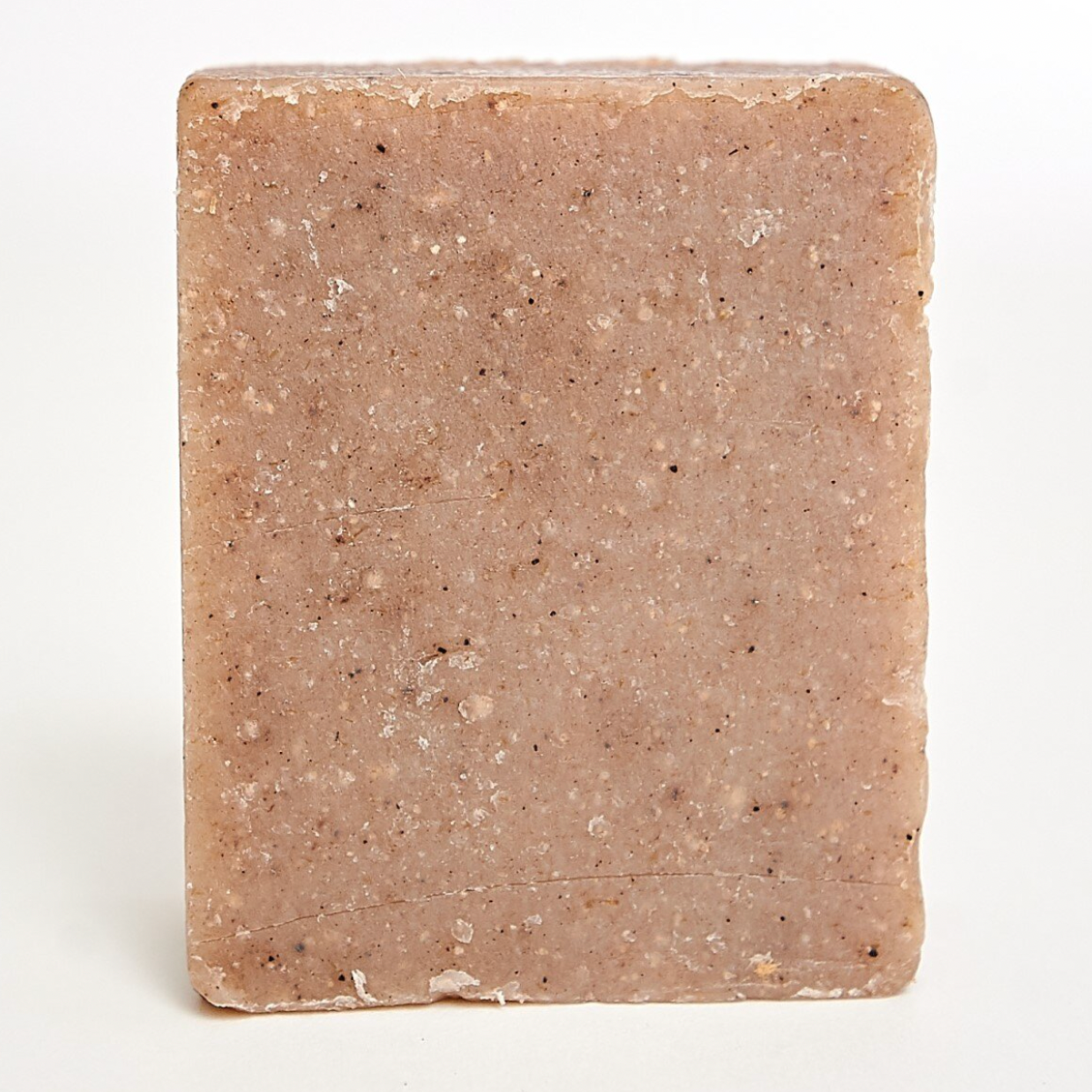 Tangie Liquid Laundry Concentrate, ideal for sensitive skin, stands upright on a white background with its rich brown hue and textured surface featuring small dark specks—perfect for gentle laundry routines.