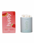 A pink box labeled “Huppy Kids Toothtabs” with watermelon and strawberry graphics sits next to a white container, both featuring small white tablets—an innovative toothpaste alternative from Huppy with nano-hydroxyapatite.