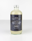 A clear Zerra & Co. Makeup Remover bottle with a black label featuring text and a barcode, filled with cloudy pale yellow liquid for sensitive skin, stands upright on a white surface against a white background.