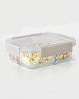 Glass food storage container with a gray lid on a white background