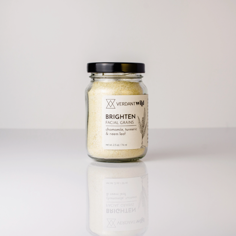 glass jar of facial grains on white background