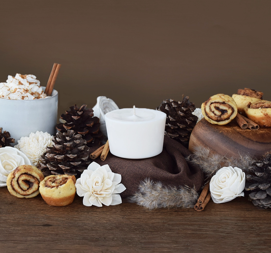 zero waste wax candle refill on brown background with cinnamon sticks and pine cones