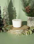 wax candle refill glacial pine scent on green backdrop with pine decor