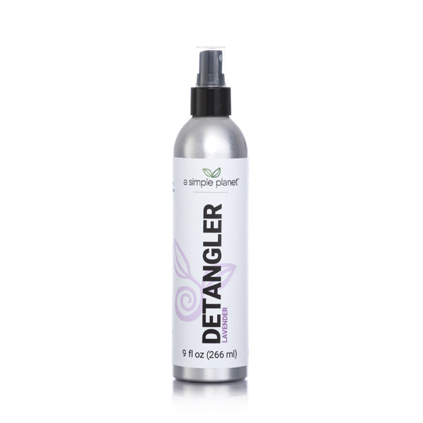 A tall 9 fluid oz mist bottle of a simple planets plant based and biodegradable detangler spray. It has a black lid and a white and purple label. 