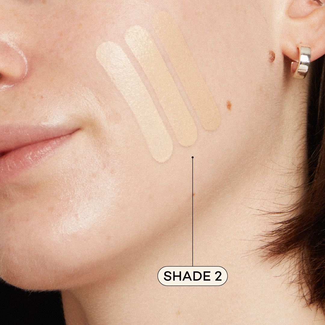 Light skinned woman featuring light foundation swatched on cheek