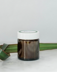 The Bright Body Clear Skin Potion Jar sitting right side up on a white background.  