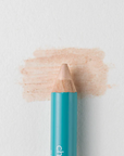 A close up on the Cheekbone Beauty vegan mini eyeshadow pencil and a swatch behind the pencil tip. This is the shade honey calcite, a champagne with light shimmer. 