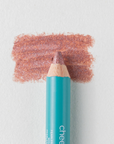 A close up on the Cheekbone Beauty vegan mini eyeshadow pencil and a swatch behind the pencil tip. This is the shade Rose Quartz, a warm pink with light shimmer. 