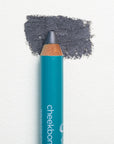 A close up on the Cheekbone Beauty vegan mini eyeshadow pencil and a swatch behind the pencil tip. This is the shade onyx, a smoky charcoal with light shimmer. 