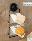 The Dip and Drip wall mount installed in a shower with cream colored Life Persevering soap trays holding shampoo and conditioner bars. 