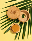 Mini Dip travel case with the coaster removed and sitting on its own holding a  conditioner bar. 
