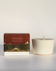 Midnight Orchard Candle refill next to box on white backdrop