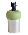 A Stainless steel and silicone floating tea infuser. The top silicone part is green with a cute black cat charm on top of it.