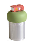 A Stainless steel and silicone floating tea infuser. The top silicone part is green with a brown book with a heart on its spine charm on top of it.