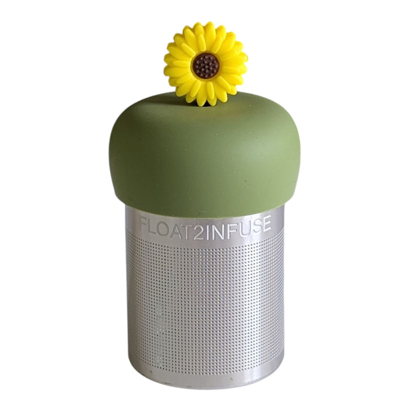 A Stainless steel and silicone floating tea infuser. The top silicone part is green with a yellow sunflower charm on top of it.