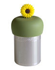 A Stainless steel and silicone floating tea infuser. The top silicone part is green with a yellow sunflower charm on top of it.