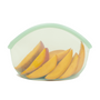 A Green Transparent reusable silicone bag with sliced mango in it on a white background.