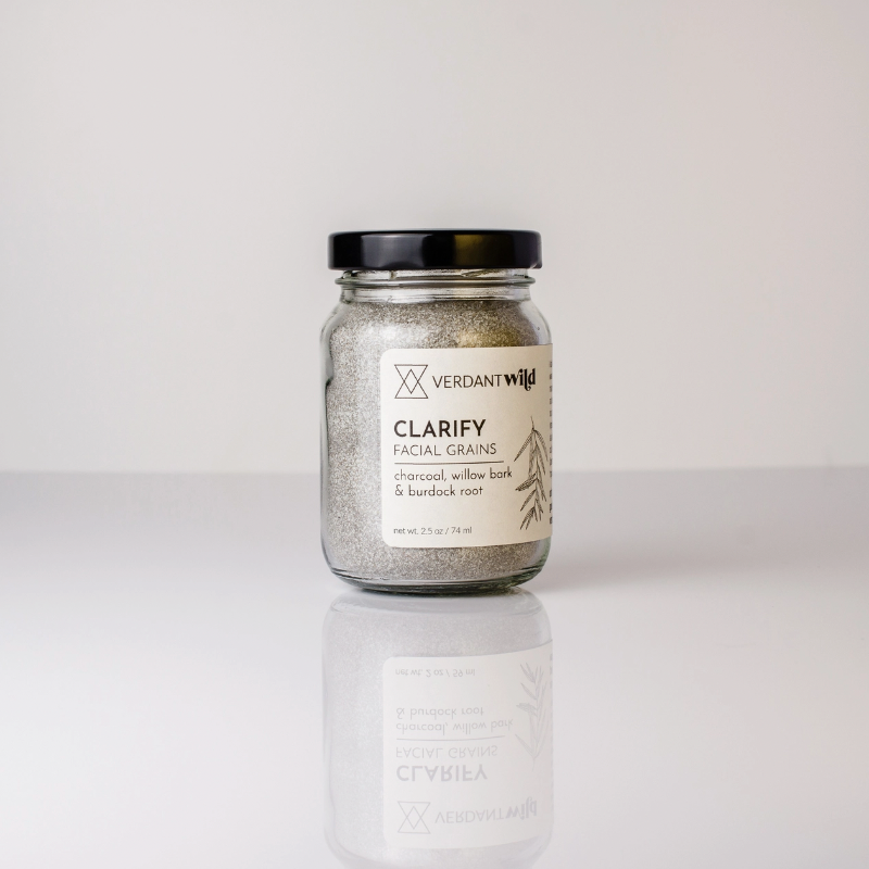 glass jar of facial grains on white backdrop