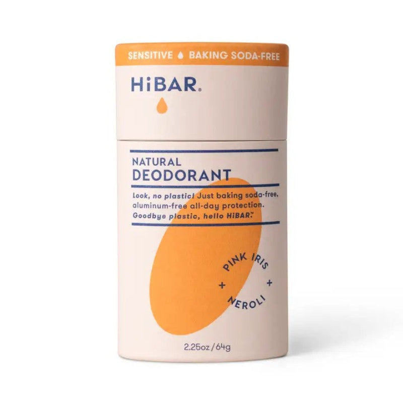 A orange paper deodorant tube with a orange oval hibar branding on it in the Pink-iris and Neroli Scent in the Sensitive formula. 