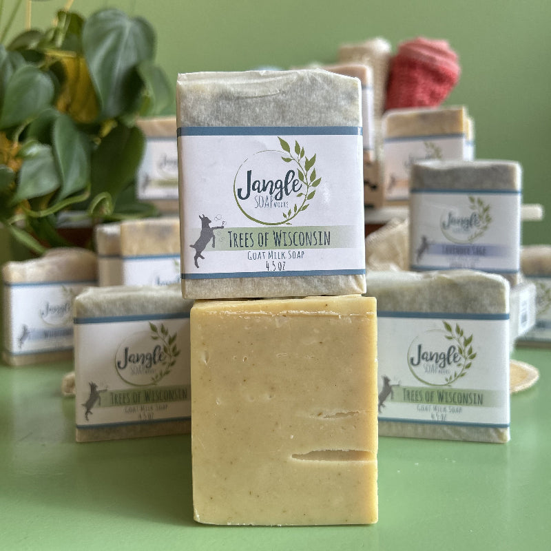 Jangle Soaps Trees of Wisconsin Goat's Milk Soap wrapped in white paper and on top of a bulk loaf of the same soap.