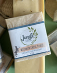Jangle Soaps Wisconsin Cheese Please! Goat's Milk Soap wrapped in white paper and on top of a bulk loaf of the same soap.
