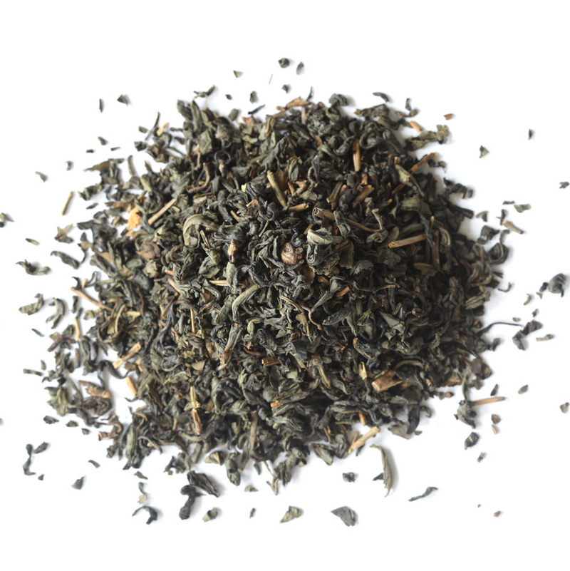 Loose leaf Jasmine Green Tea by Mountain Rose Herbs spread out on a white background.