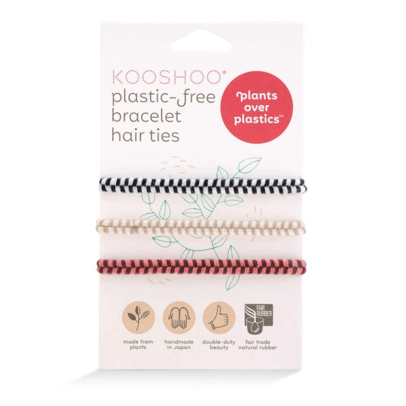 Pack of biodegradable handmade hair ties designed to fit comfortably around your wrist.  Three chevron hair ties wrap around the packaging. One hair ties is Black and white, one is beige and white and one is pink and brown. 