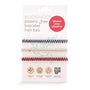 Pack of biodegradable handmade hair ties designed to fit comfortably around your wrist.  Three chevron hair ties wrap around the packaging. One hair ties is Black and white, one is beige and white and one is pink and brown. 