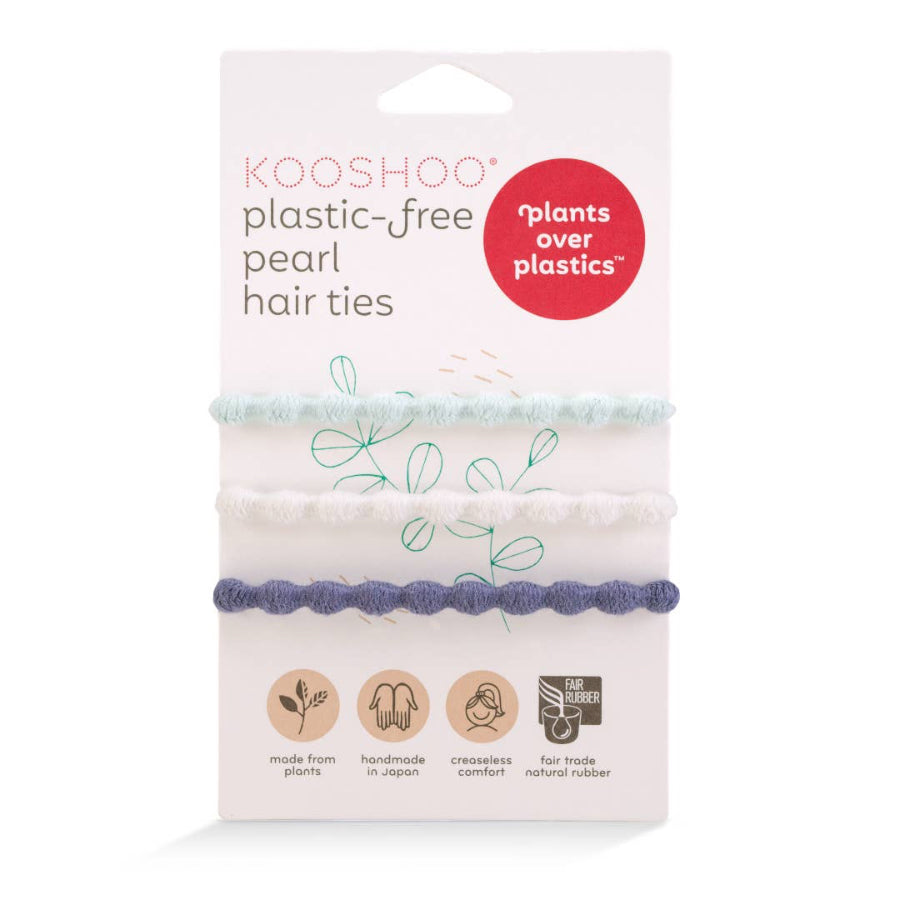 Pack of biodegradable handmade hair ties designed to fit comfortably around your wrist.  Three pearl hair ties wrap around the packaging. One hair tie is white, one is baby blue,  and one is a denim blue. 