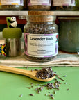 A refillable jar of lavender buds with a cork lid and an attachable spoon. 
