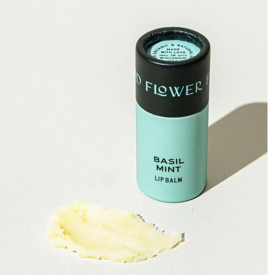 A tube of basil mint lip balm in an eco friendly paper tube that is blue and black. 