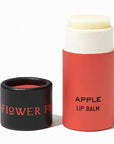 A tube of apple lip balm in an eco friendly paper tube that is red and black. 
