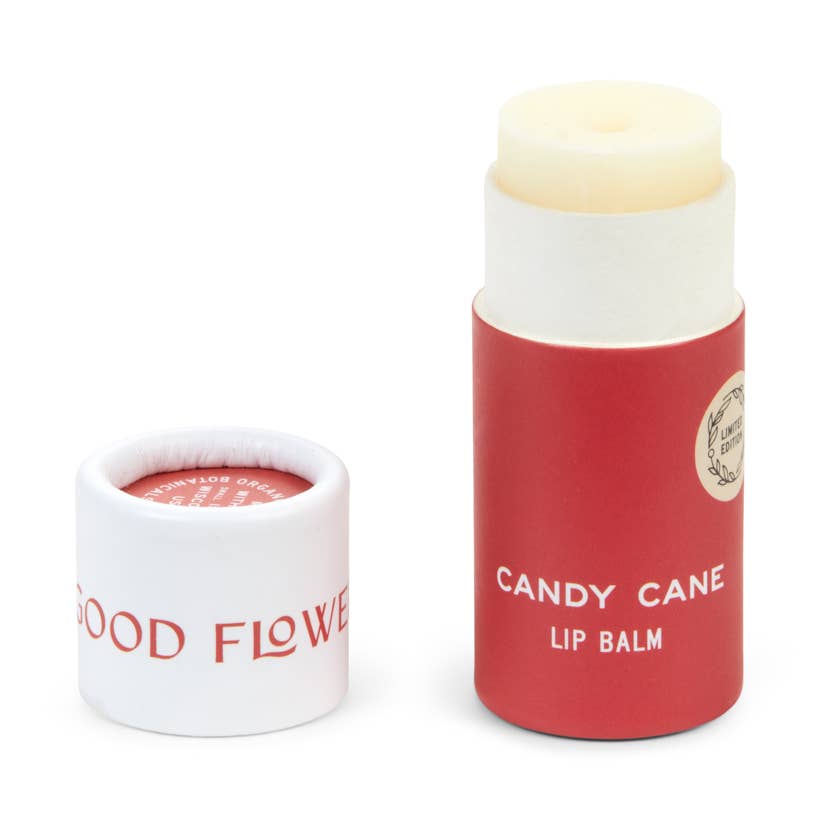 A tube of Candy Cane lip balm in an eco friendly paper tube that is red and white. 