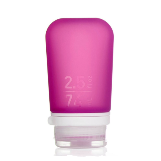 A medium 2.5 oz silicone bottle in the color magenta on a white surface. 