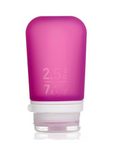 A medium 2.5 oz silicone bottle in the color magenta on a white surface. 